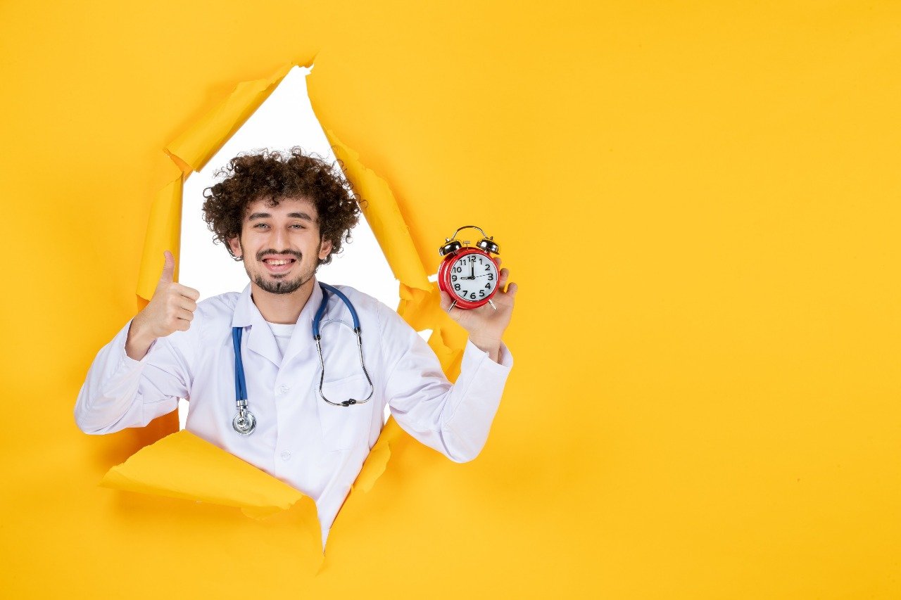Man happily looking through a torn paper hole