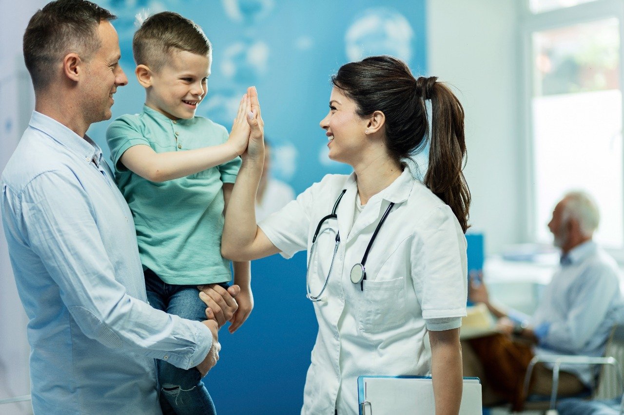 Doctor with an elderly patient and his grandson